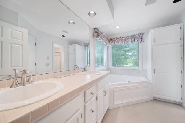 6180 Storm Haven Ct, Lewis Center, OH 43035 - bathroom with a garden tub, double vanity, and recessed lighting