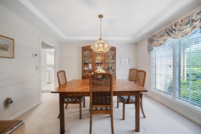 6180 Storm Haven Ct, Lewis Center, OH 43035 - dining area with a chandelier, light colored carpet, a raised ceiling, washer / clothes dryer, and ornamental molding