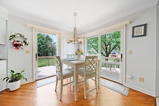 6180 Storm Haven Ct, Lewis Center, OH 43035 - dining area featuring a chandelier, crown molding, wood finished floors, and baseboards