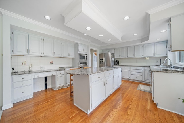 6180 Storm Haven Ct, Lewis Center, OH 43035 - kitchen with appliances with stainless steel finishes, a kitchen island, tasteful backsplash, light wood-style flooring, and light stone countertops