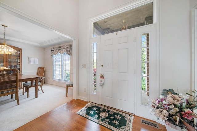 6180 Storm Haven Ct, Lewis Center, OH 43035 - entrance foyer with a chandelier, light wood-type flooring, and baseboards