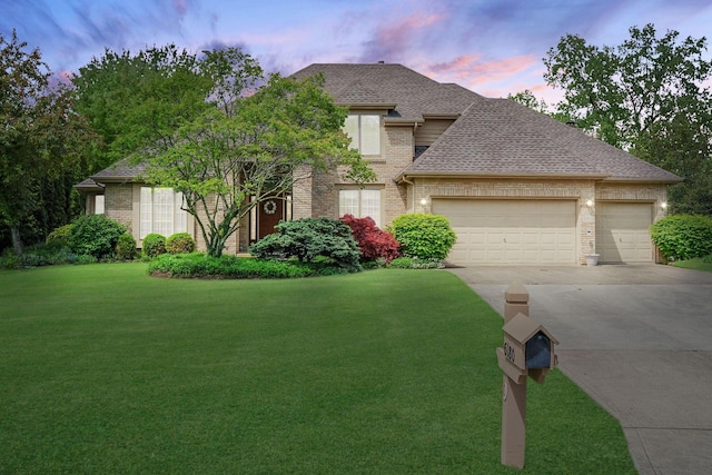 6180 Storm Haven Ct, Lewis Center, OH 43035 - view of front facade with brick siding, concrete driveway, an attached garage, a front lawn, and a shingled roof