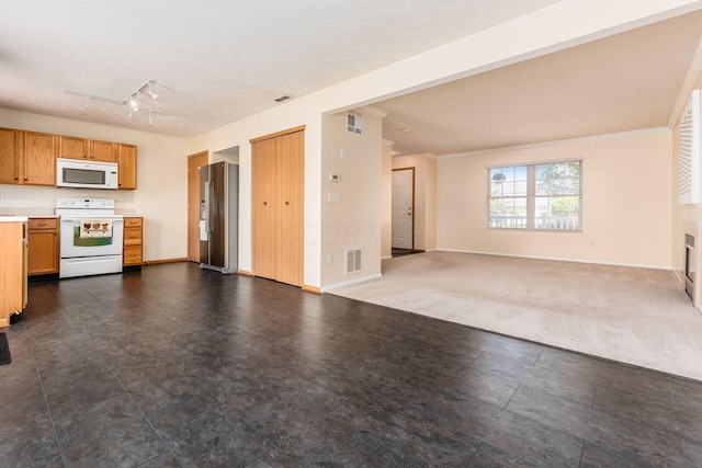 kitchen featuring white appliances, light countertops, baseboards, open floor plan, and visible vents
