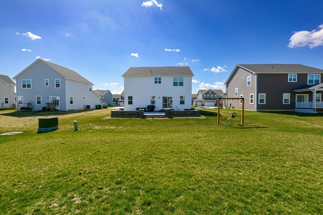 rear view of property with a yard and a residential view