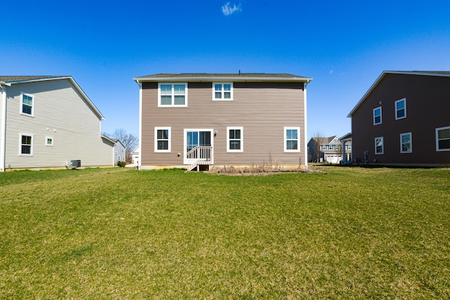 back of house with a lawn and cooling unit