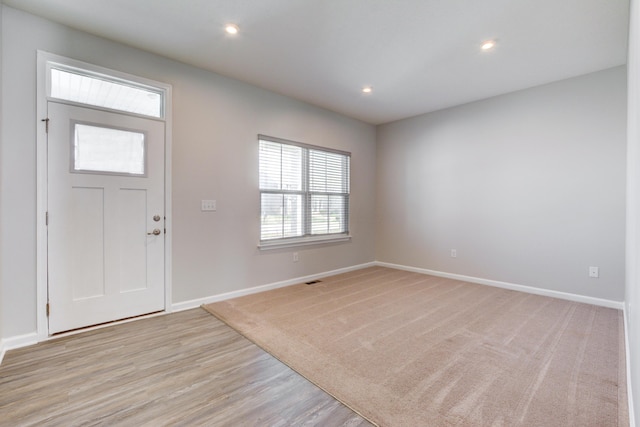 entrance foyer featuring light wood-style flooring, baseboards, and recessed lighting