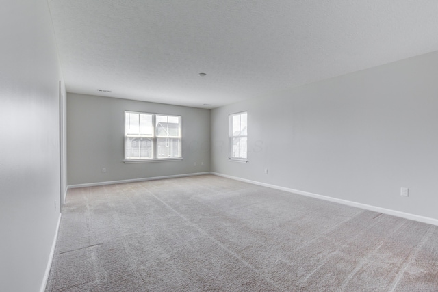 carpeted empty room with baseboards