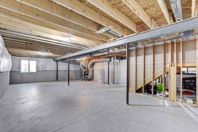 below grade area with heating unit and electric water heater