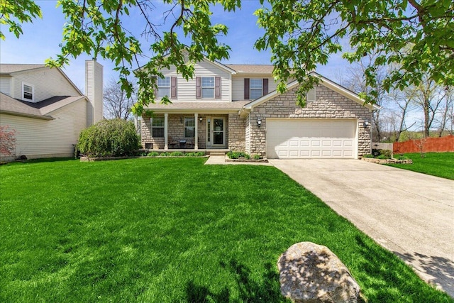 traditional home featuring stone siding, concrete driveway, fence, and a front yard