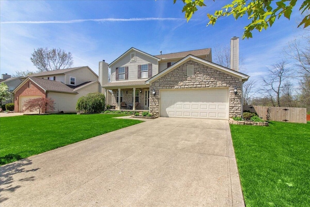 view of front of home featuring an attached garage, fence, a front yard, and stone siding