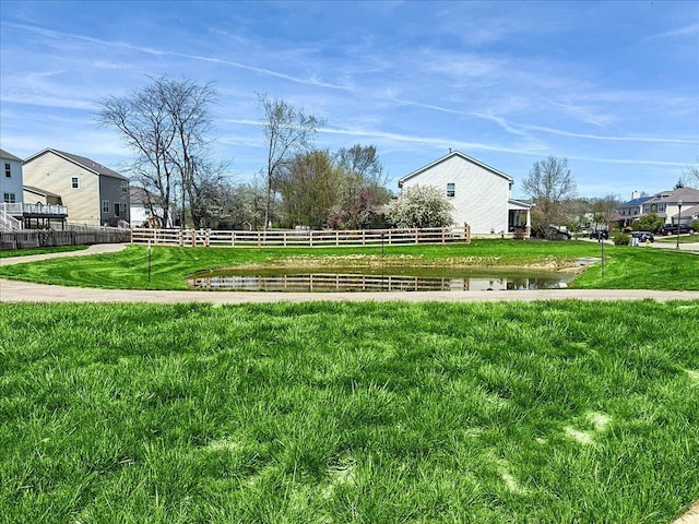 view of yard featuring a water view and fence