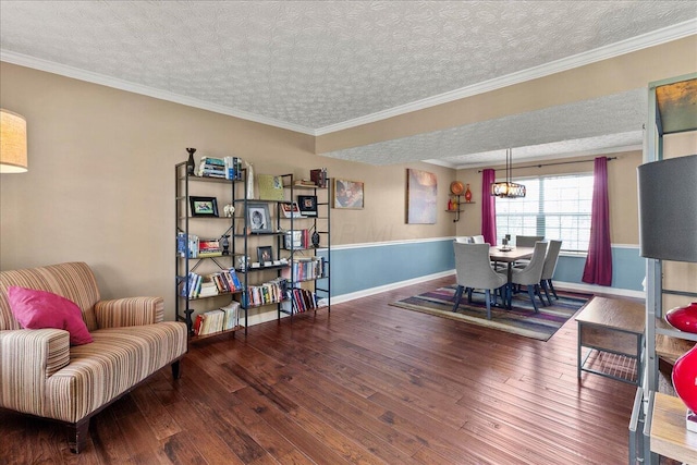 dining space featuring crown molding, a textured ceiling, wood-type flooring, and baseboards