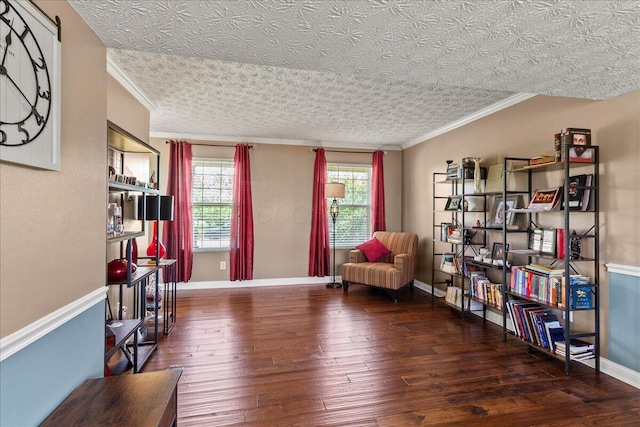 sitting room with ornamental molding, hardwood / wood-style flooring, and baseboards