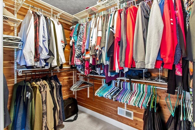 walk in closet featuring visible vents and carpet floors