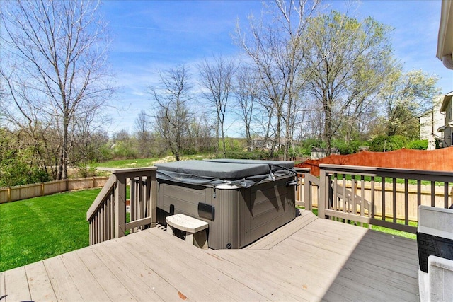 wooden deck with a lawn, a hot tub, and a fenced backyard