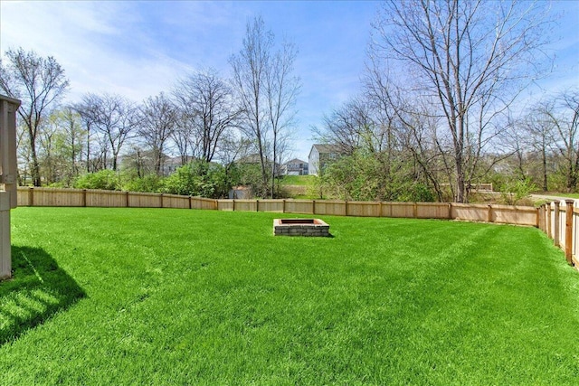 view of yard with a fire pit and a fenced backyard