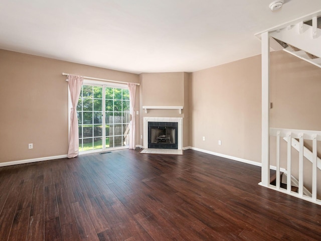 5690 Kilbury Ln Unit 120D, Hilliard, OH 43026 - unfurnished living room featuring hardwood / wood-style floors, a tile fireplace, and stairway