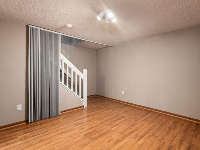 5690 Kilbury Ln Unit 120D, Hilliard, OH 43026 - unfurnished room featuring light wood-type flooring and a textured ceiling