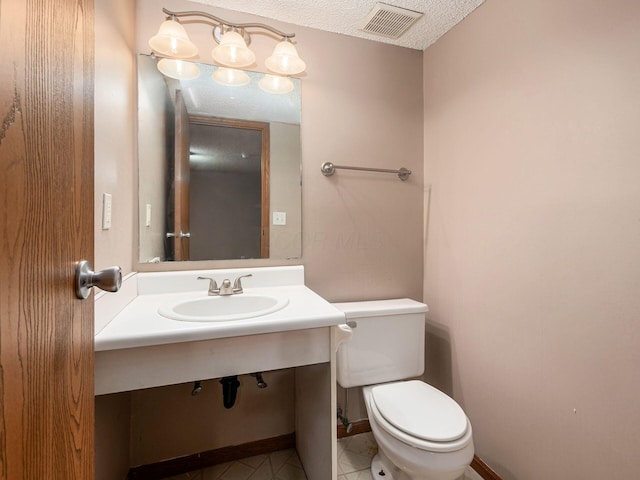 5690 Kilbury Ln Unit 120D, Hilliard, OH 43026 - bathroom featuring vanity, a textured ceiling, and tile patterned floors