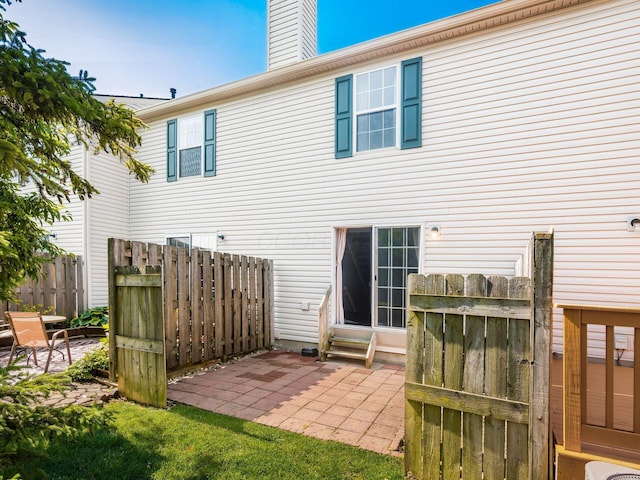 5690 Kilbury Ln Unit 120D, Hilliard, OH 43026 - rear view of property with a patio area, entry steps, and a chimney