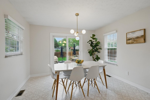 dining area featuring light floors and baseboards
