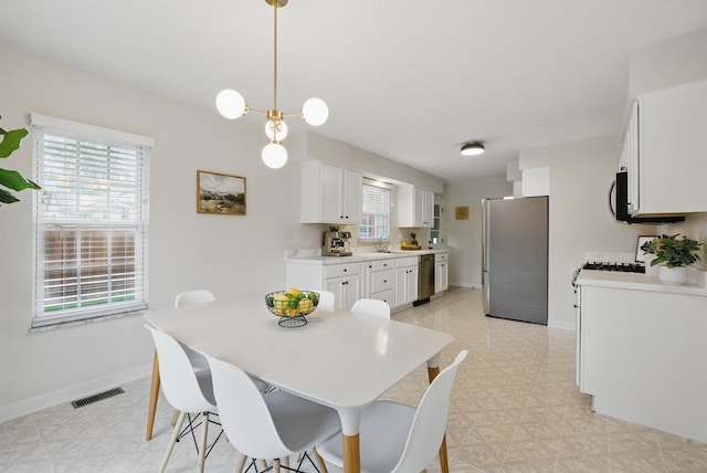 dining area featuring light flooring and baseboards