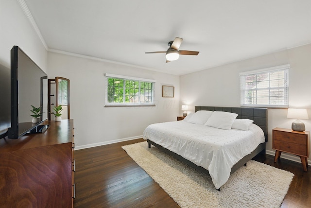 bedroom featuring dark wood finished floors, baseboards, crown molding, and a ceiling fan