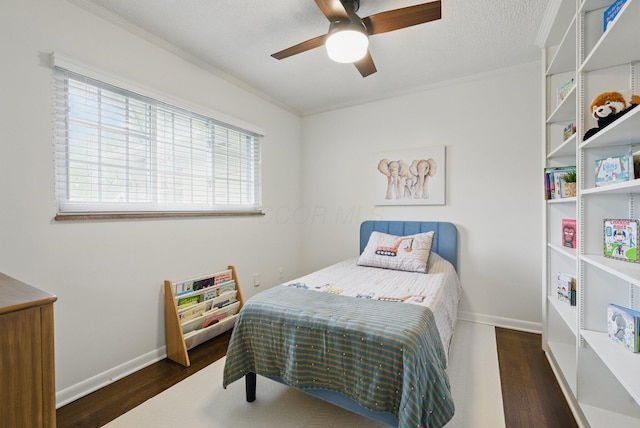 bedroom featuring crown molding, wood finished floors, multiple windows, and baseboards