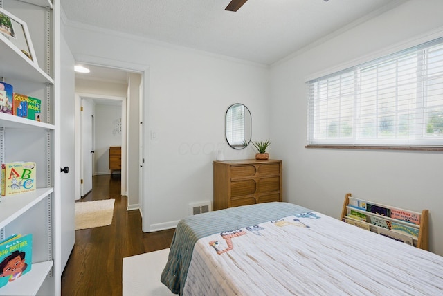 bedroom featuring ornamental molding, dark wood-type flooring, a ceiling fan, and baseboards