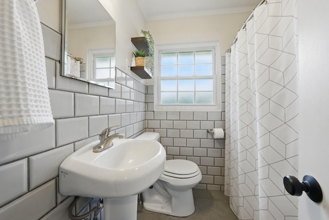 full bath featuring tile walls, toilet, curtained shower, ornamental molding, and a sink