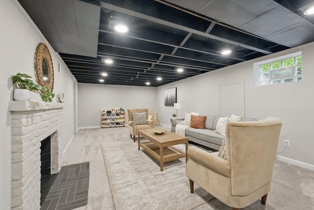 carpeted living room featuring baseboards and a fireplace