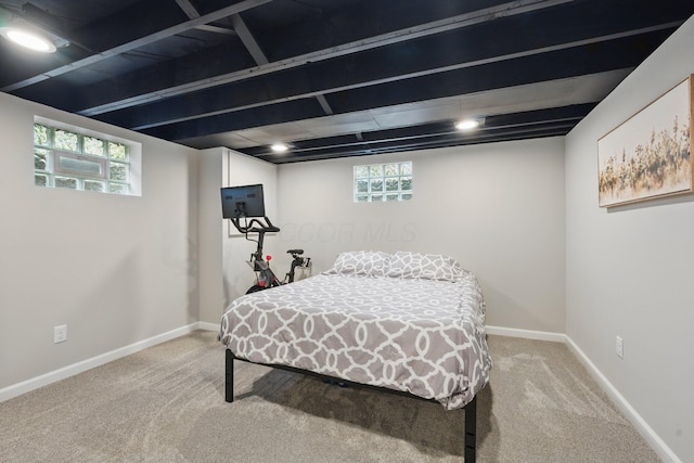 bedroom featuring light colored carpet and baseboards