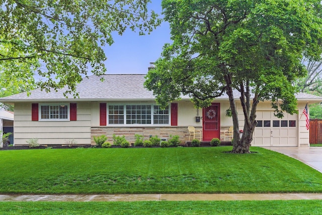 ranch-style house featuring an attached garage, driveway, a front yard, and roof with shingles