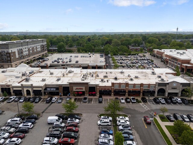bird's eye view of a commercial area and a tree filled landscape