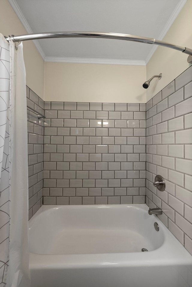 bathroom with ornamental molding and shower / tub combo