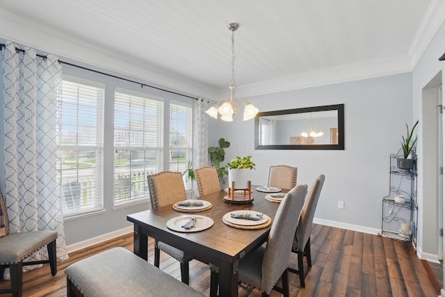 dining room featuring a chandelier, dark wood finished floors, baseboards, and ornamental molding