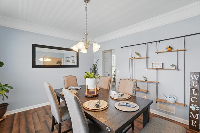 dining space featuring baseboards, visible vents, an inviting chandelier, and ornamental molding