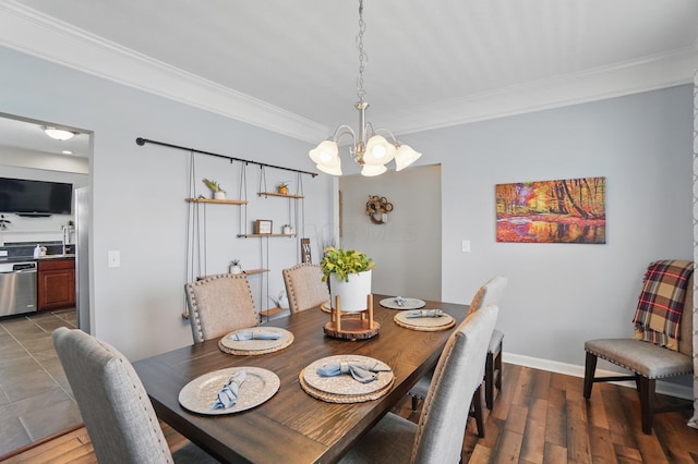 dining room with dark wood-type flooring, baseboards, a notable chandelier, and ornamental molding