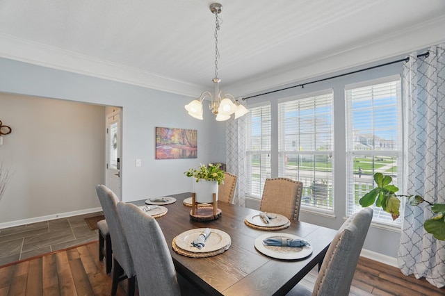 dining area with wood finished floors, a healthy amount of sunlight, and an inviting chandelier