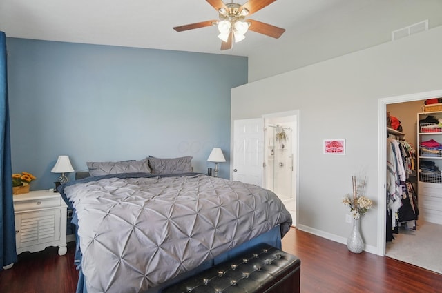 bedroom featuring visible vents, baseboards, wood finished floors, a closet, and a walk in closet