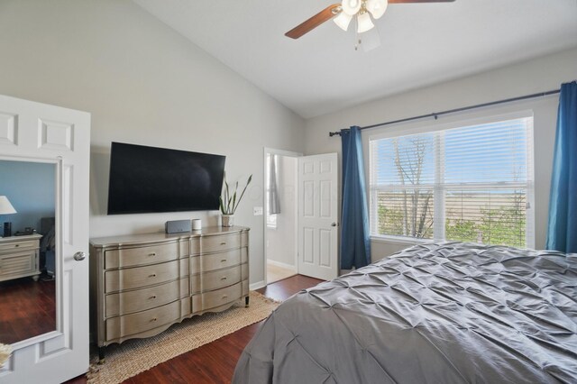 bedroom featuring dark wood finished floors, a ceiling fan, and high vaulted ceiling