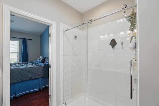 bathroom featuring a shower stall, wood finished floors, and ensuite bathroom