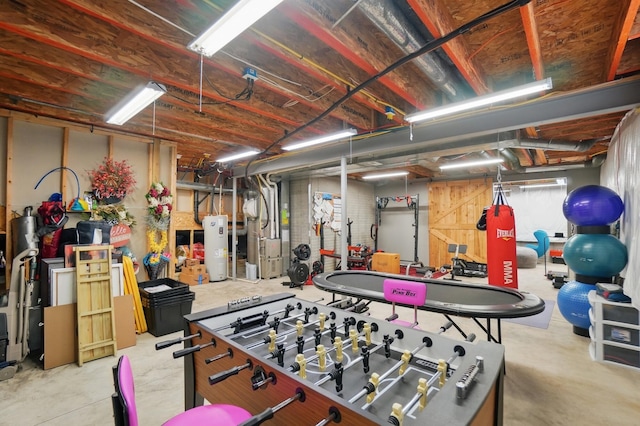 playroom with water heater, heating unit, and concrete flooring