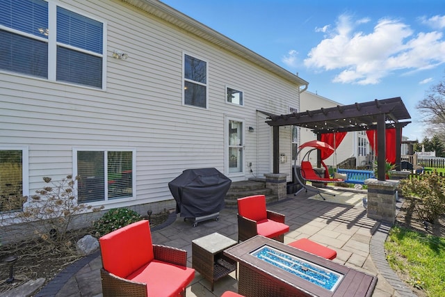 view of patio / terrace with a pergola, grilling area, and an outdoor fire pit