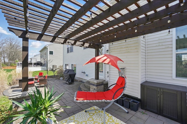 view of patio / terrace with fence and a grill