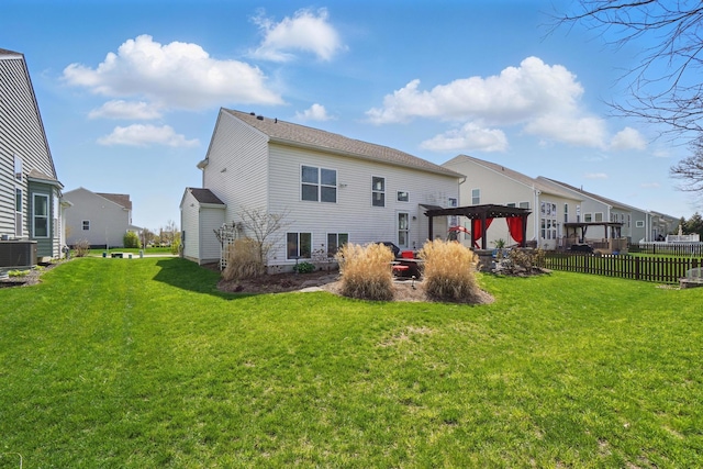rear view of property featuring fence, a pergola, a yard, central air condition unit, and a residential view