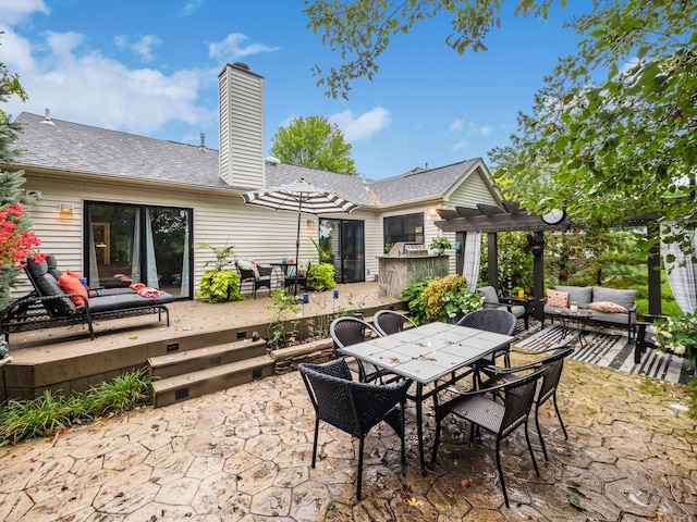 view of patio / terrace with a pergola, outdoor dining space, a wooden deck, and an outdoor living space