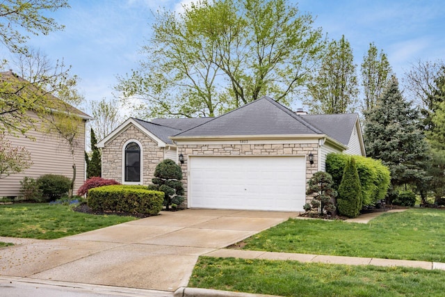 ranch-style home with a front yard, stone siding, concrete driveway, and a garage