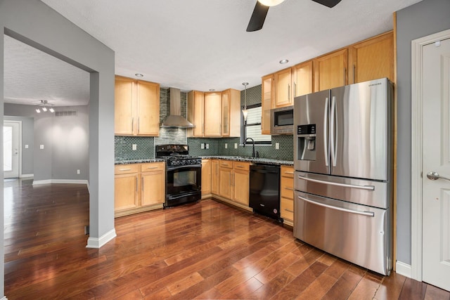 kitchen with black appliances, dark wood-style flooring, baseboards, a ceiling fan, and wall chimney exhaust hood