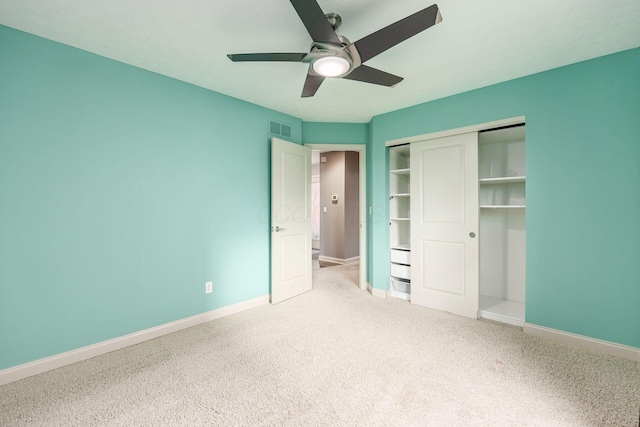 unfurnished bedroom featuring visible vents, baseboards, a closet, carpet, and a ceiling fan